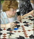 A woman quilting.